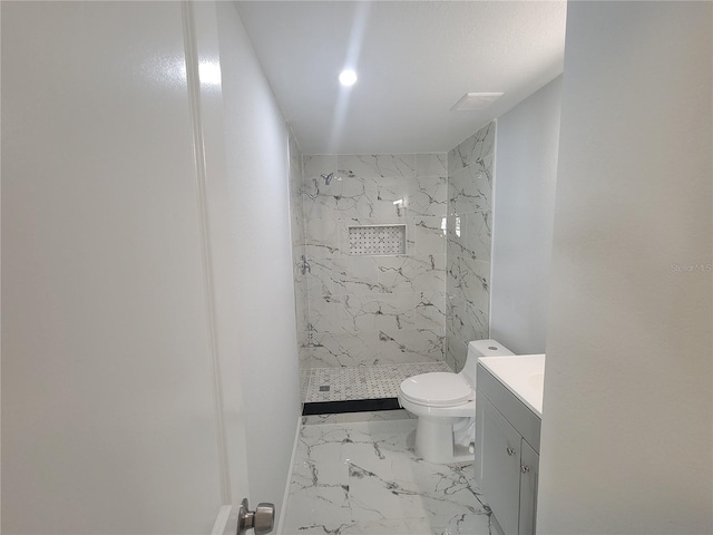 bathroom featuring a stall shower, marble finish floor, vanity, and toilet