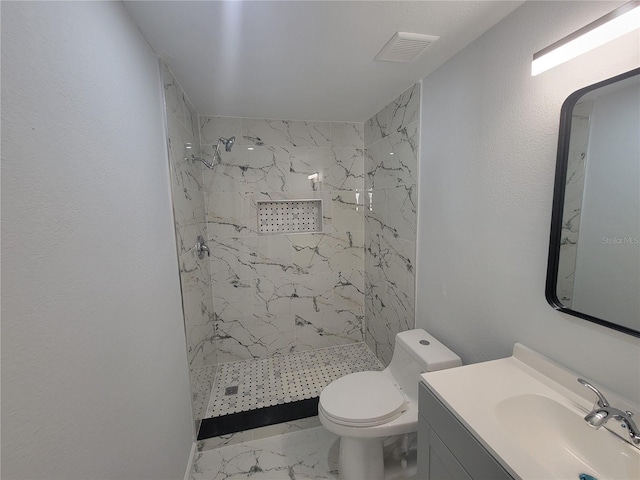 full bath with a marble finish shower, visible vents, toilet, marble finish floor, and vanity