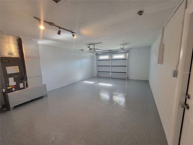 garage with a garage door opener and heating unit