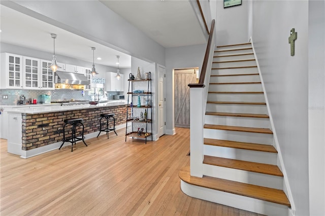 stairs featuring wood-type flooring