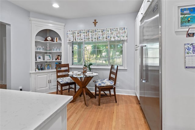 dining space featuring recessed lighting, baseboards, and light wood finished floors