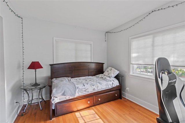 bedroom featuring baseboards and wood finished floors