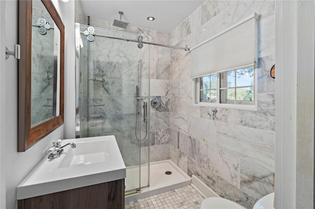 full bathroom featuring a stall shower, vanity, and toilet