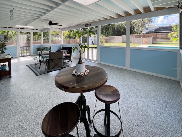 sunroom / solarium featuring ceiling fan