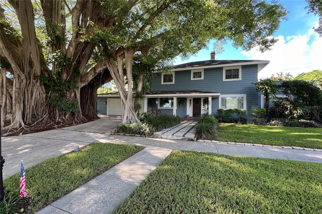 view of front of property featuring a chimney and a front yard