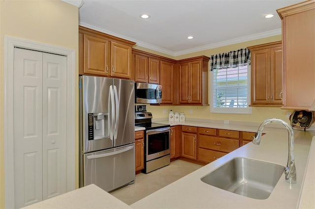 kitchen featuring light tile patterned flooring, stainless steel appliances, a sink, light countertops, and ornamental molding