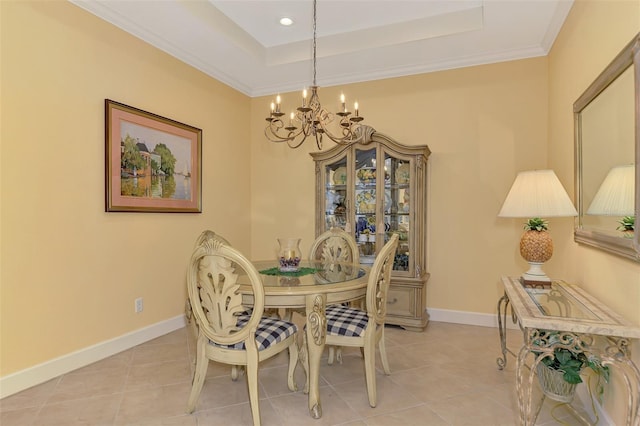 dining area with light tile patterned floors, baseboards, a raised ceiling, and a chandelier