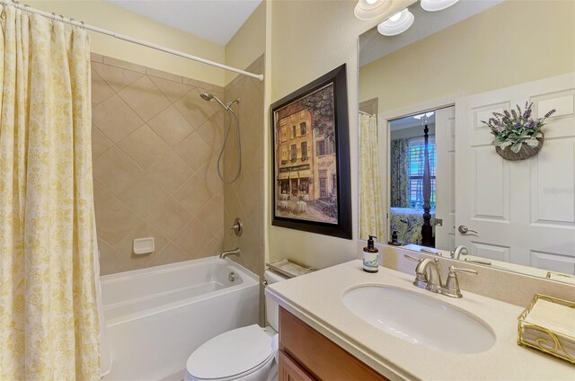 bathroom with toilet, shower / bath combo with shower curtain, and vanity