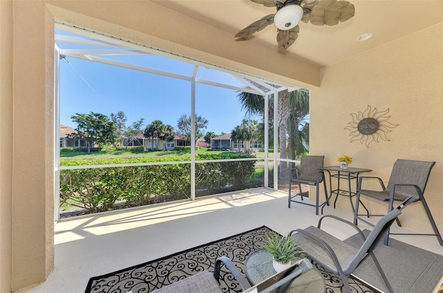 sunroom featuring a ceiling fan