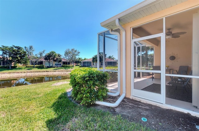 view of yard with a water view and a sunroom