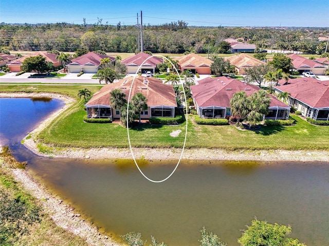 drone / aerial view featuring a water view and a residential view