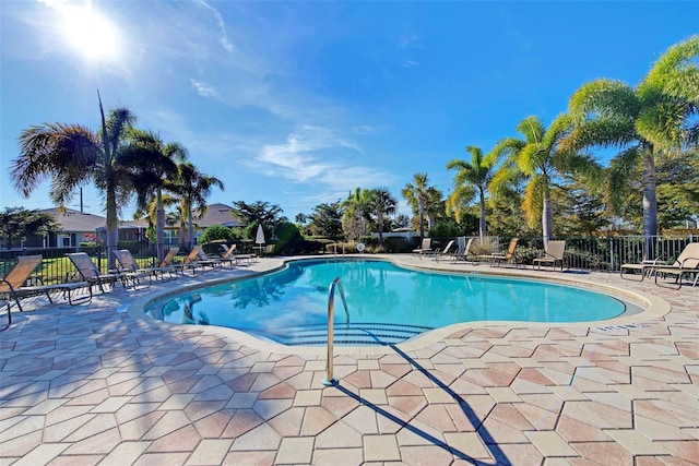 pool featuring fence and a patio