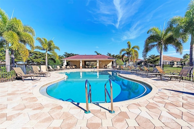 pool featuring a patio and fence