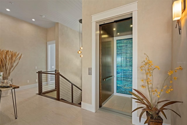 hall featuring elevator, recessed lighting, baseboards, and an upstairs landing