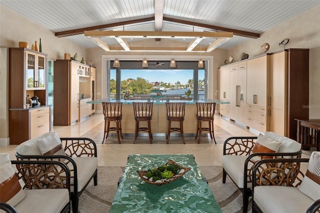 living area featuring lofted ceiling with beams and light tile patterned floors