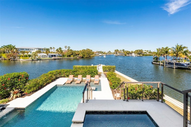 outdoor pool featuring a water view and a patio