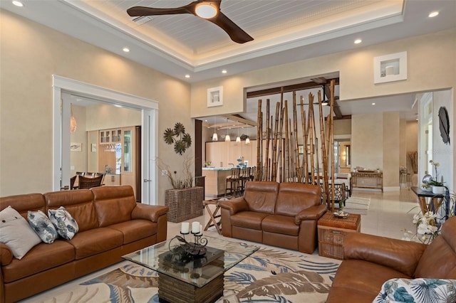 tiled living area featuring visible vents, a raised ceiling, a ceiling fan, and recessed lighting