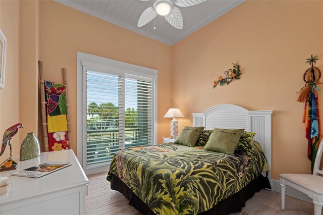 bedroom featuring baseboards, light wood finished floors, a ceiling fan, and crown molding