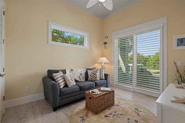 living room featuring a healthy amount of sunlight, light wood-style flooring, and baseboards