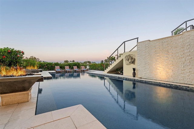 pool featuring a patio area and stairway