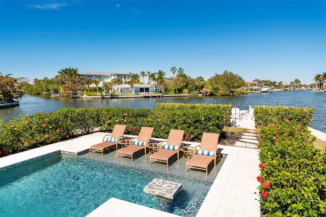 view of swimming pool with a patio area and a water view