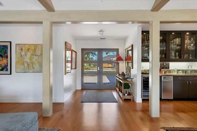 1610 S Lake Shore Dr, Sarasota, FL 34231 - foyer featuring indoor wet bar, beam ceiling, wood finished floors, and french doors
