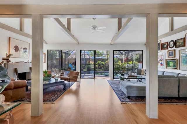 1610 S Lake Shore Dr, Sarasota, FL 34231 - living area with ceiling fan, wood finished floors, and vaulted ceiling with beams