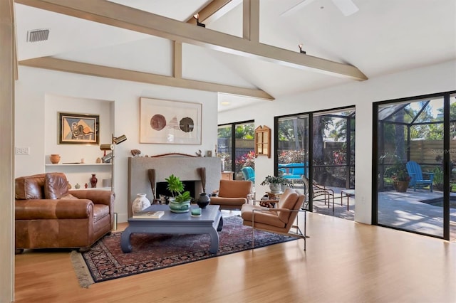 1610 S Lake Shore Dr, Sarasota, FL 34231 - living area with visible vents, beam ceiling, wood finished floors, and a fireplace
