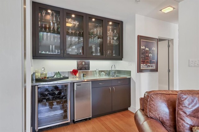 1610 S Lake Shore Dr, Sarasota, FL 34231 - bar with a sink, refrigerator, wine cooler, light wood finished floors, and wet bar