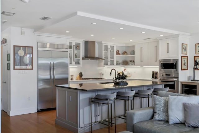 1610 S Lake Shore Dr, Sarasota, FL 34231 - kitchen with visible vents, a sink, open floor plan, wall chimney exhaust hood, and built in appliances