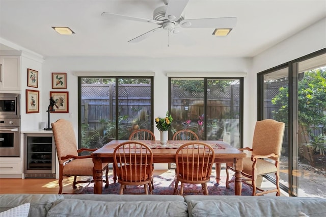 1610 S Lake Shore Dr, Sarasota, FL 34231 - dining space with a ceiling fan, light wood-style flooring, beverage cooler, and a wealth of natural light