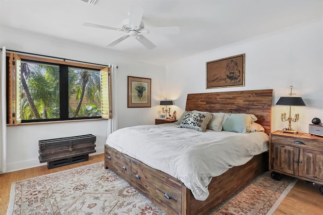 1610 S Lake Shore Dr, Sarasota, FL 34231 - bedroom with baseboards, ceiling fan, and wood finished floors