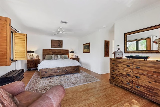 1610 S Lake Shore Dr, Sarasota, FL 34231 - bedroom featuring ceiling fan, wood finished floors, visible vents, and baseboards