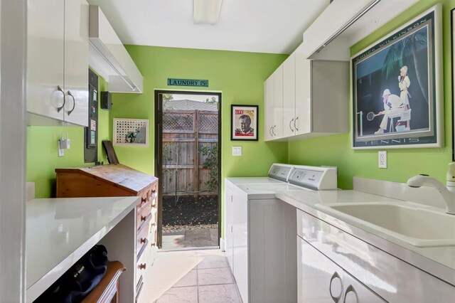 1610 S Lake Shore Dr, Sarasota, FL 34231 - laundry room featuring washing machine and clothes dryer, cabinet space, and a sink