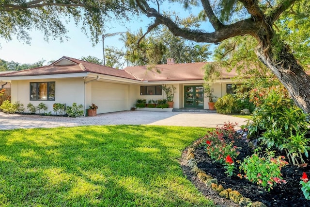 1610 S Lake Shore Dr, Sarasota, FL 34231 - ranch-style home featuring stucco siding, driveway, a front lawn, a tile roof, and an attached garage