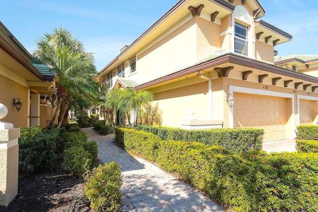 view of property exterior featuring an attached garage and stucco siding