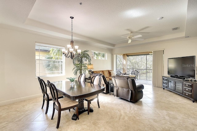 dining area featuring a raised ceiling, visible vents, and a healthy amount of sunlight