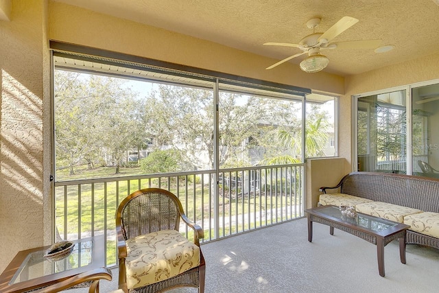 sunroom / solarium featuring a ceiling fan