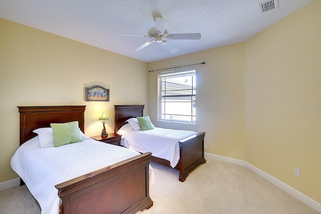 bedroom with visible vents, light carpet, ceiling fan, a textured ceiling, and baseboards