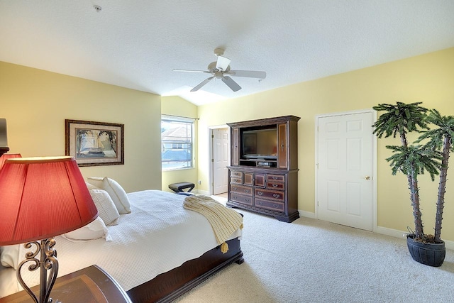 bedroom with lofted ceiling, light carpet, ceiling fan, a textured ceiling, and baseboards