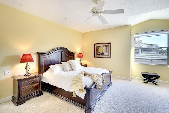 bedroom with light colored carpet, visible vents, vaulted ceiling, ceiling fan, and baseboards