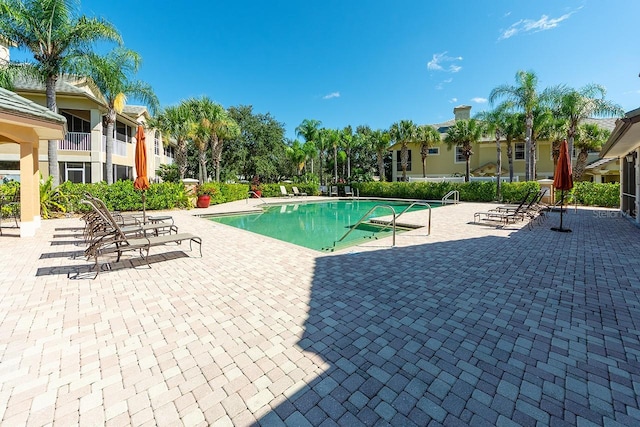 community pool with a patio area