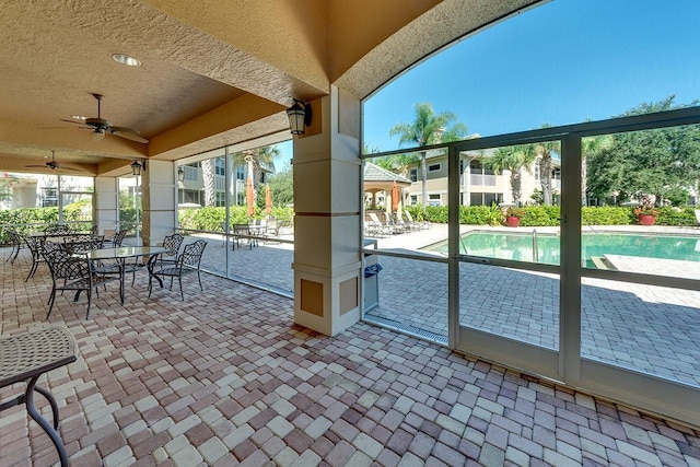 exterior space featuring a ceiling fan and a wealth of natural light