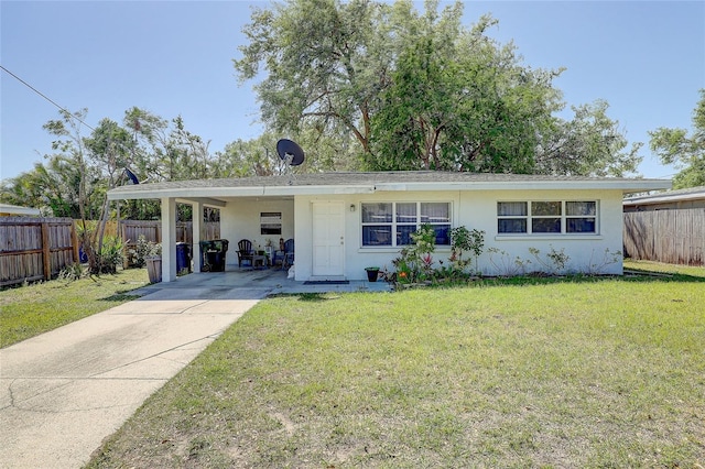 single story home featuring a front lawn, fence, stucco siding, an attached carport, and concrete driveway