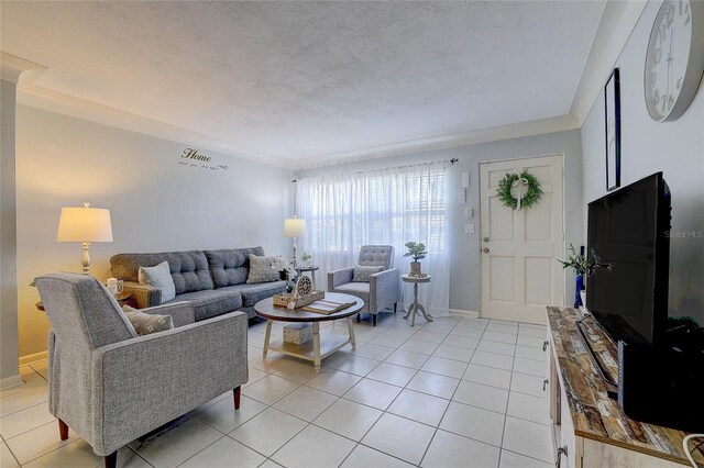 living room featuring baseboards, a textured ceiling, and light tile patterned flooring