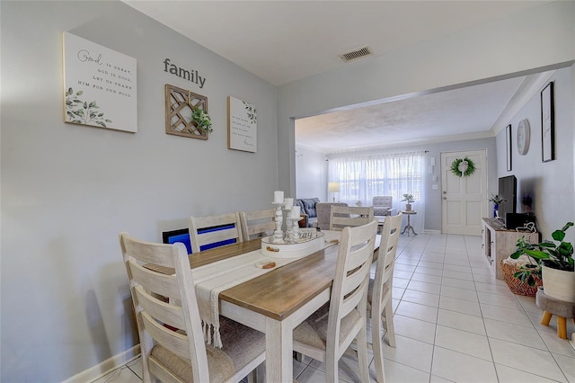 dining space with baseboards, visible vents, and light tile patterned floors