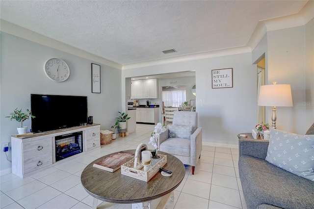 living area with light tile patterned floors, baseboards, a textured ceiling, and visible vents