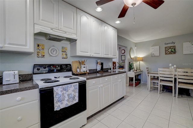 kitchen featuring ceiling fan, electric range oven, white cabinets, under cabinet range hood, and light tile patterned flooring