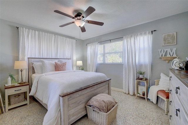 bedroom featuring baseboards, a ceiling fan, and light speckled floor