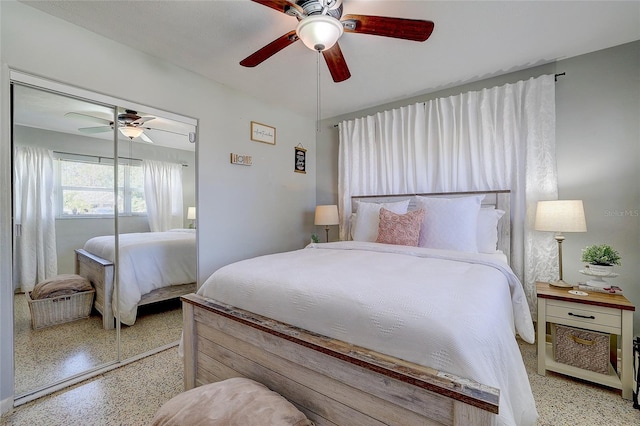 bedroom with a closet, ceiling fan, and light speckled floor